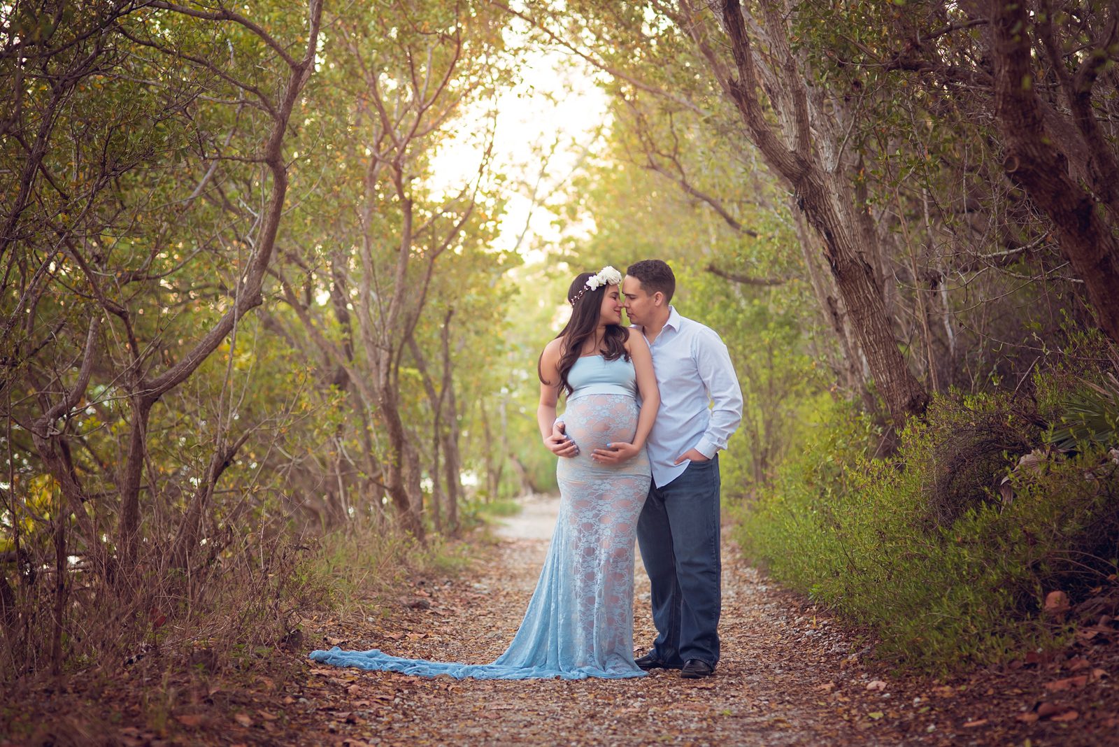 Pregnant couple outdoors in the woods by Miami maternity photographer