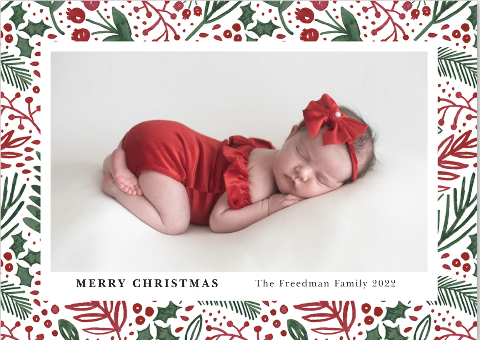 Christmas card featuring a photo of a newborn baby in red