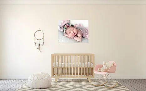 A photo of a baby sleeping displayed above a crib
