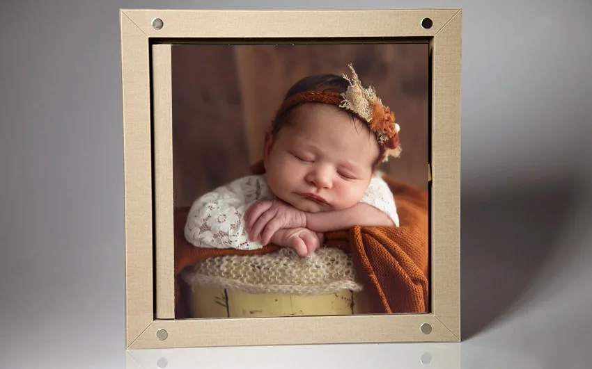 A newborn baby album displayed in a frame