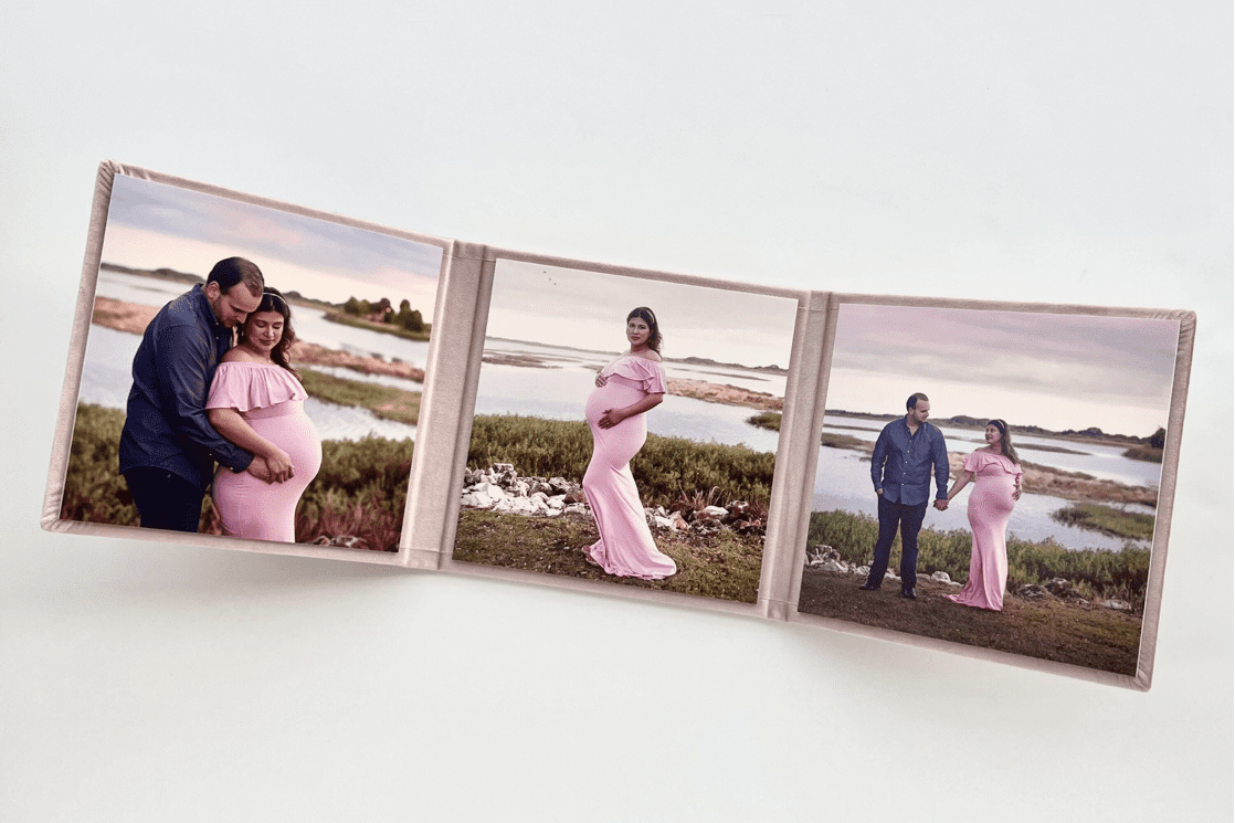 A maternity photo book with three photos of a pregnant woman.